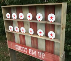 a wooden sign with red and white stars on it