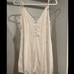 Tags On. Never Worn. Excellent Condition Summer V-neck Jumpsuit For Daywear, Summer Cream Overall Jumpsuits And Rompers, Casual Cream Jumpsuits And Rompers For Summer, Cream Jumpsuits And Rompers For Spring Loungewear, Summer Beige Jumpsuits And Rompers For Date Night, Summer Loungewear Mini Jumpsuits And Rompers, Summer Mini Length Jumpsuits And Rompers For Loungewear, Summer Style Jumpsuits And Rompers For Daywear With V-neck, Casual Sleeveless Cream Jumpsuits And Rompers