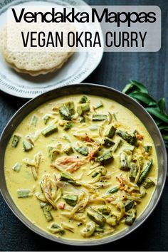 vegan okra curry in a bowl with crackers and bread on the side