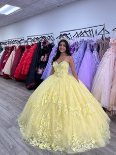 Radiate sunshine and elegance on your quinceanera with this breathtaking Yellow Ball Gown. This dress is crafted from luxurious tulle fabric and boasts a voluminous ball gown silhouette that creates a show-stopping effect, making you the center of attention as you enter the room. The romantic sweetheart neckline beautifully frames your chest, while the sleeveless design enhances the graceful, flowing lines of the gown. The Intricate appliqued details add a touch of artistry, elevating the dress Quiencera Dresses Yellow, Yellow Damas Dresses, Yellow Theme Quinceanera, Qinsenara Dresses Yellow, Yellow Quincenera Dresses, Sweet 16 Yellow Dresses, Orange 15 Dresses Quinceanera, Yellow And White Quinceanera Dress, Yellow Debut Gown