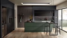 a kitchen with wooden floors and green cabinets