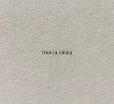 the words trust in time written on white paper