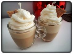 two cups filled with hot chocolate and whipped cream