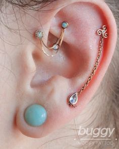 an ear with three different piercings attached to it