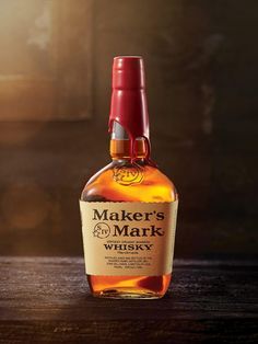 a bottle of maker's mark whisky on a wooden table