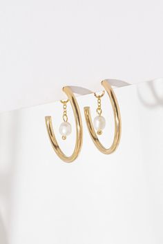 Just another pair of hoop earrings? Think again! Liz Hoop Earrings are a  showstopper!  Made of gold or silver plated brass, according to your choice, and decorated with a delicate chain and a freshwater pearl pendant. The plating on this item is nickel-free, which means it is great for sensitive skin as well. The jewelry will arrive in our branded packaging. We can attach a personal note upon request.  Diameter: 2.5 cm / 1" All images are the property of Shlomit Ofir Jewelry Design. Mystic Eye, Earrings Classic, Think Again, Earrings Pearl, Delicate Chain, Beautiful Gift Boxes, Jewelry Earrings Hoops, Silver Hoop Earrings, Bridal Earrings