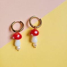 Handmade golden stainless steel hoop earrings with freshwater pearls and murano glass mushroom pendant. 🍄 Gold Earrings With Mushroom Design For Gift, Gift Gold Earrings With Mushroom Design, Gold Mushroom Design Drop Earrings, Metal Mushroom Design Jewelry As Gift, White Mushroom Design Drop Earrings, Golden Hoop Earrings, Mushroom Pendant, Golden Hoops, Glass Mushrooms