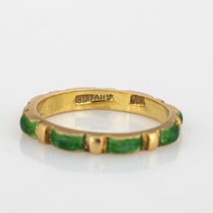 Vintage Tiffany & Co green enamel ring crafted in 18 karat yellow gold (circa 1970s to 1980s).    Green enamelled panels are continuous around the band for a seamless look. The enamel is in fair condition with enamel loss present. The slim 2.5mm wide band (0.09 inches) is great worn alone or stacked with your fine jewellery from any era.  The ring is in fair condition. We have not cleaned it in order to preserve the patina and collector value.   Particulars:  Weight: 2.8 grammes  Stones:  N/A  S Vintage Green Enamel Ring For Anniversary, Vintage Green Enamel Ring For Gift, Classic Green Enamel Jewelry, Vintage Green Enamel Ring Gift, Green Vintage Enamel Ring For Gift, Gold Art Deco Enamel Ring, Art Deco Gold Enamel Anniversary Ring, Formal Green Enamel Ring With Polished Finish, Modernist Green Rings For Anniversary