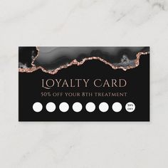 a black and gold business card with white circles on the front, and an image of a