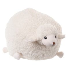 a white sheep stuffed animal laying on top of it's back legs and head