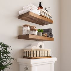 two wooden shelves above a toilet in a bathroom