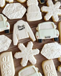 decorated cookies are arranged on a table with snowflakes and sweaters in the shape of cars