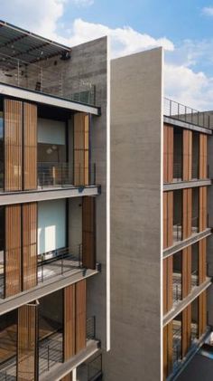 an apartment building with wooden balconies on the balcony