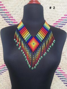 Mexican necklace, Huichol necklance, huchol choker, beaded choker. huichol art. This choker is a piece with a compound made by Huichol artisans, made entirely by hand, unique pieces, very colorful boho type, for any occasion. The Huichol artisans base all their works and their designs on visions they have during their sacred rituals proper to their ethnicity, The Huicholes inhabit the states of Nayarit, Jalisco, Zacatecas and Durango. Piece made by artisans nayaritas. Sent anywhere in the world Traditional Multicolor Tiny Beads Choker, Traditional Multicolor Beaded Choker, Handmade Colorful Traditional Beaded Necklaces, Colorful Traditional Beaded Necklaces For Festivals, Traditional Handmade Colorful Beaded Necklaces, Traditional Colorful Handmade Beaded Necklace, Colorful Handmade Traditional Beaded Necklace, Traditional Handmade Colorful Beaded Necklace, Traditional Multicolor Handwoven Choker