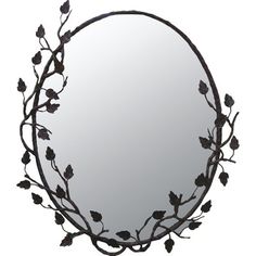 a round mirror with leaves and vines on it's sides, hanging from the wall