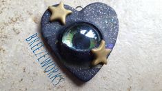 a blue heart with two gold stars hanging from it's side on a wall