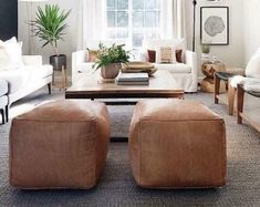 a living room with couches, chairs and a coffee table in front of a window