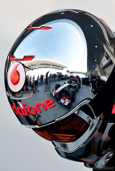 a helmet is reflected in the side mirror of a motorcycle