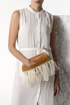 Bring a glamorous edge to your evening look with the Domna design clutch leather bag. Handmade of fine quality leather and silky feathers, this boho chic evening bag comes in 2 colors, camel brown (waxed tan) and black. ● Size: width 29 x height 16cm (width 11.4 x height 6.3 inches) ● Without lining ● Dust bag included Discover the whole collection with our unique leather bags: www.etsy.com/shop/GreekChicHandmades?ref=seller-platform-mcnav&section_id=15827194 Back to the shop: www.etsy.com/shop/GreekChicHandmades SHIPPING Every clutch is handmade upon order and ready to be shipped in 3-7 business days. We ship from Greece to all over the world via DHL express with delivery time 1-5 business days.  Please be aware that delivery may experience delays due to your country's customs procedures. Beige Leather Handheld Clutch, Chic Clutch Wallet With Detachable Strap, Handheld Leather Clutch For Parties, Elegant Brown Bag With Fringe, Leather Envelope Clutch With Dust Bag, Leather Pouch Clutch For Parties, Beige Clutch Wallet For Evening, Beige Evening Clutch Wallet, Chic Formal Bags With Fringe