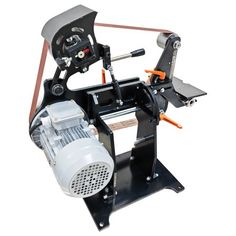 a machine that is sitting on top of a white surface with an orange and black handle