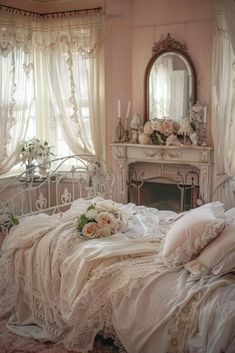 a white bed sitting in a bedroom next to a window covered in curtains and pillows