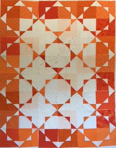 an orange and white quilt with squares on it