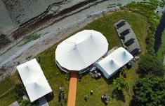 an aerial view of some tents in the grass