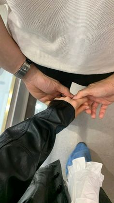 two people standing next to each other with their hands on one another's leg