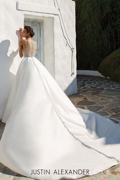 a woman in a white wedding dress posing for the camera