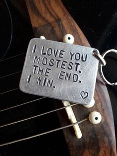 a metal keychain that reads, i love you most the end i win