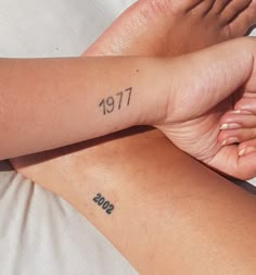 two people with matching tattoos on their arms