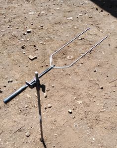 an antenna is laying on the ground in the dirt