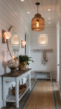 a hallway with white walls and wood flooring next to a wooden table topped with plants