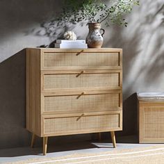 a wooden dresser sitting next to a potted plant