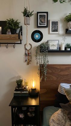 a bedroom with various plants and pictures on the wall