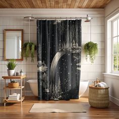 a bathroom with a shower curtain that has an image of the moon and trees on it