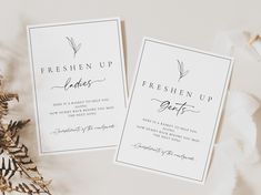 two cards with the words freshen up on them next to some plants and leaves