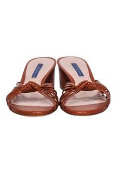 Step out in style with these Stuart Weitzman sandals! Crafted with luxe cognac tan leather and a knot detail, they'll add boho-chic vibes to any look. Pair them with a cozy floral frock and be ready for turning heads! Size 8 Made in Spain 100% Leather Knot front detail Heel height 2" Elegant Brown Summer Mules, Cognac Open Toe Sandals For Summer, Brown Padded Heel Sandals For Beach, Brown Beach Sandals With Padded Heel, Brown Leather-lined Heels For Spring, Spring Brown Heels With Leather Lining, Brown Formal Mules For Summer, Brown Formal Summer Mules, Formal Brown Summer Mules