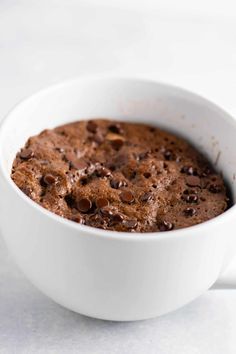 a close up of a bowl of food with chocolate chips in it on a table