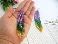 Mardi gras earrings dangle, Long statement earrings, festival beaded earrings, Women shining earrings purple green gold, mardi gras gift Looking for something to complement the festival image? Consider these earrings. -Created in the colors of the festival -Goodly combined not only with the appropriate suit but also for everyday images. -Made of quality Czech beads. -I can be a wonderful gift for the holiday. -Gift packaging and personalized postcard are available. -You can add a silver hook if Purple Dangling Beads Earrings For Party, Purple Dangling Beads Party Earrings, Colorful Beads Jewelry For Mardi Gras Party, Purple Beaded Jewelry For Mardi Gras, Colorful Beaded Jewelry For Mardi Gras Party, Purple Jewelry For Mardi Gras, Green Jewelry For Mardi Gras Party, Purple Beaded Chandelier Earrings For Party, Purple Jewelry With Gold Beads For Party