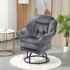 a living room with a gray chair and white rugs on the floor next to a potted plant