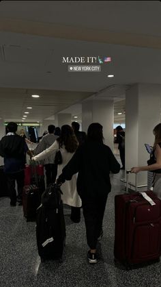 people walking through an airport with their luggage