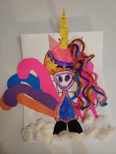 a paper cut out of a girl wearing a unicorn hat