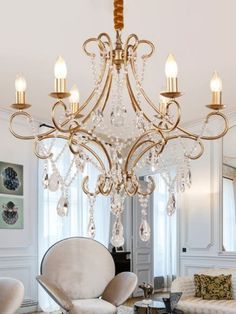 a chandelier hanging from the ceiling in a living room