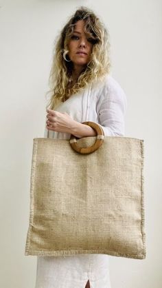 a woman is holding a large bag in her hands