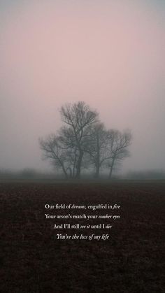 a foggy field with two trees in the distance and a poem written on it