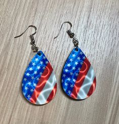 "Fourth of July Teardrop Earrings, Red White and Blue Earrings, Teardrop Style 4th of July Earring, Handmade Jewelry, Handmade Earrings Teardrop shaped earrings. The earrings measure 1.5\" x 1\" (for the teardrop part). With the hardware they are approximately 2.5 inches long.  The image is sublimated into the earring so you don't have to worry about fading or peeling of the image. They are double sided so both sides have the same image on them." Patriotic Multicolor Earrings For Independence Day, Patriotic Dangle Earrings For Independence Day, Multicolor Earrings For Independence Day Gift, Patriotic Multicolor Earrings As Gift, Red Jewelry With Ear Wire For Independence Day, Red Teardrop Hypoallergenic Earrings, Patriotic Blue Drop Earrings, Blue Patriotic Drop Earrings, Handmade Patriotic Drop Earrings