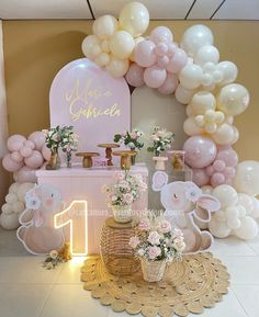 a pink and gold baby shower party with balloons, buntings, flowers and decorations