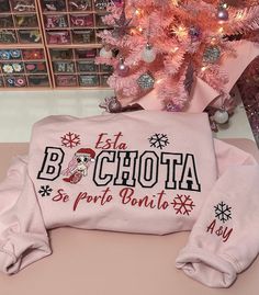 a pink christmas tree with matching sweaters on it