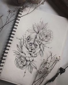 a drawing of a tiger surrounded by flowers and leaves on top of a white paper